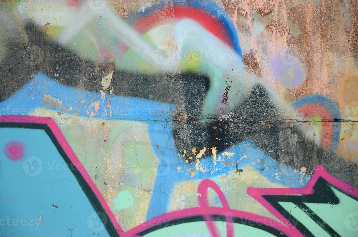 Close-up fragment of a graffiti drawing applied to the wall by aerosol paint. Background image of a modern composition of lines and colored areas. Street art concept photo