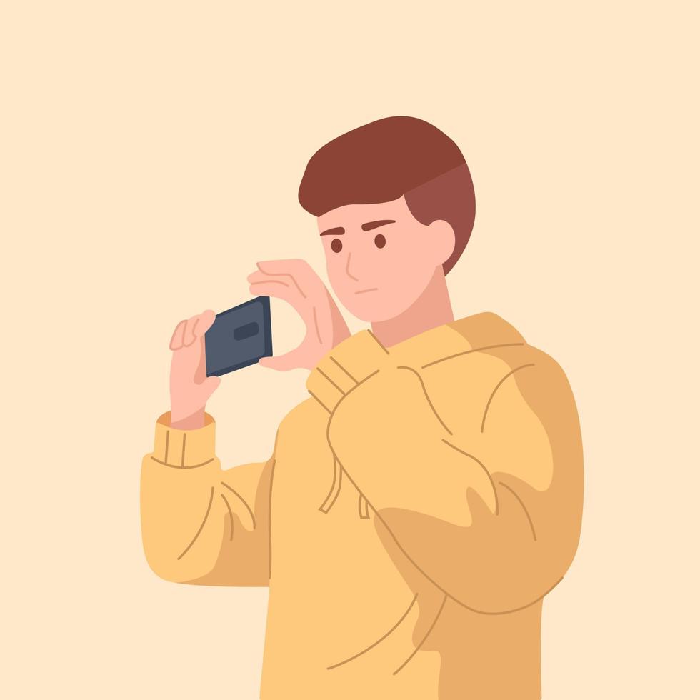 Guy in yellow hoodie taking photo or video on his phone vector