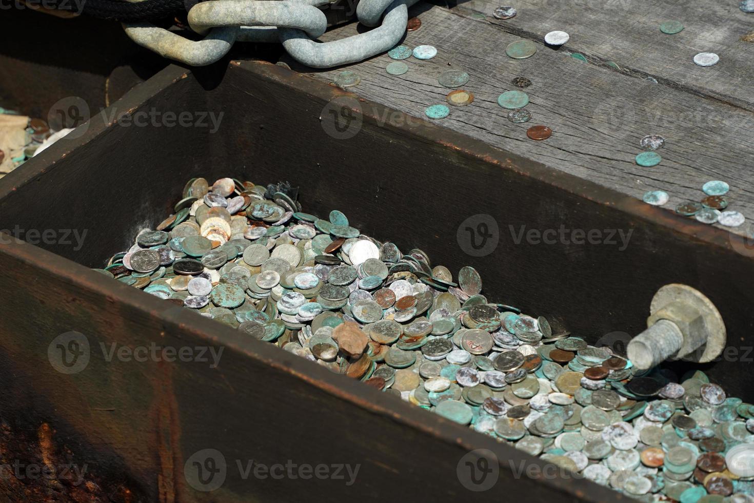 many dime coin dollar money on liberty island ferry pier wharf new york photo