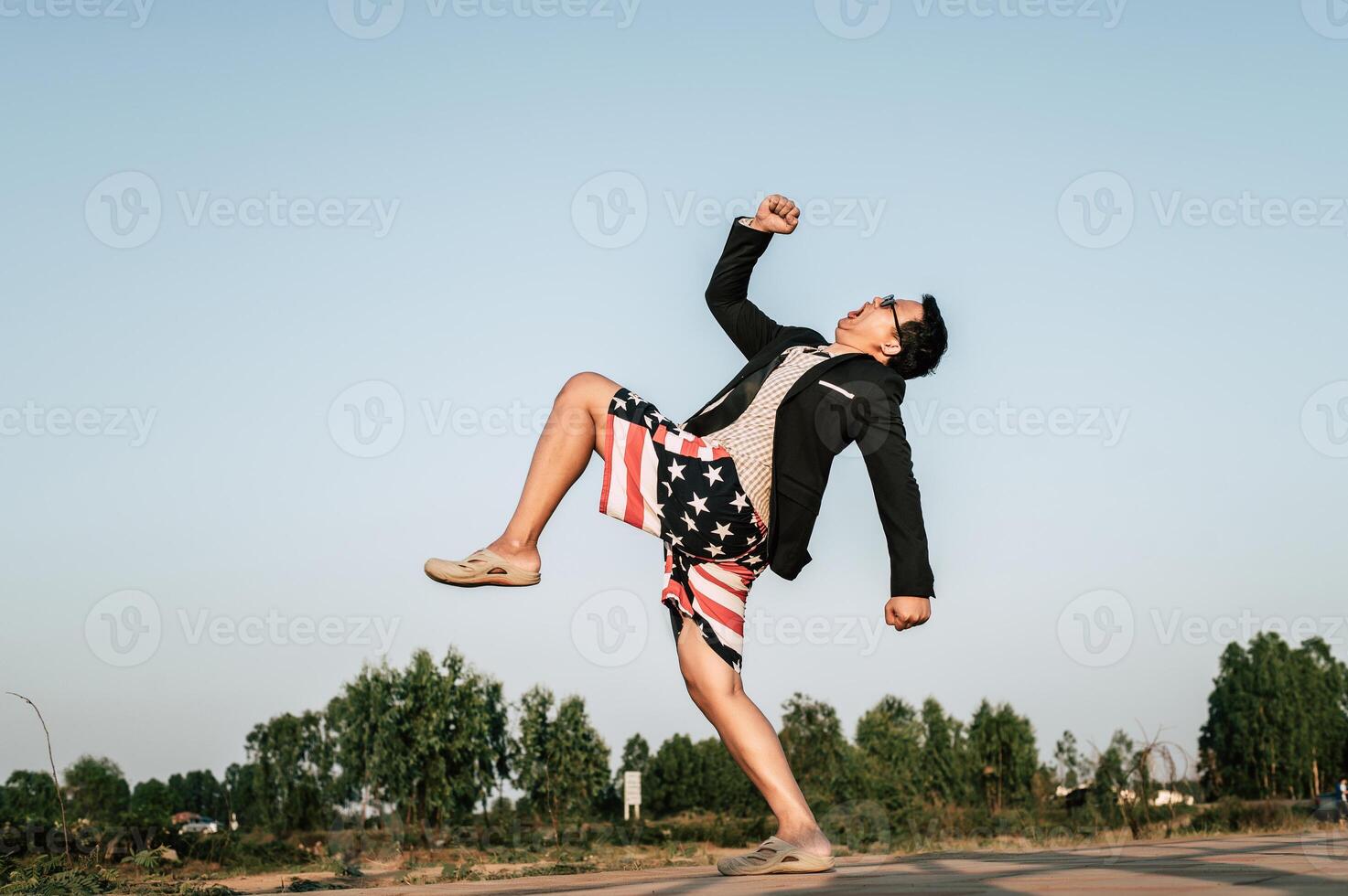 Young funny businessman man in crazy and funny manner posture photo