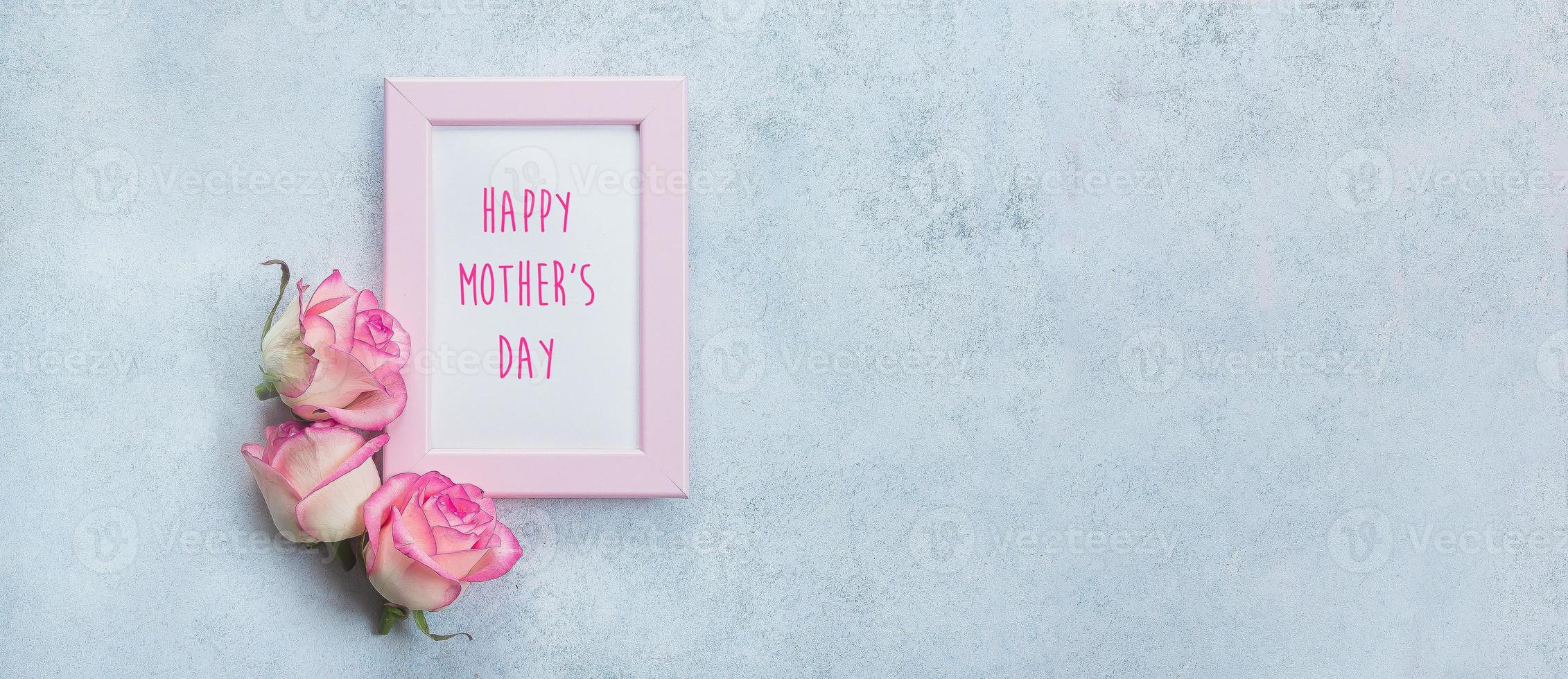 Mother's Day Card. Photo frame with greeting text and pink roses on blue background. Banner image for website. Top view, copy space, flat lay