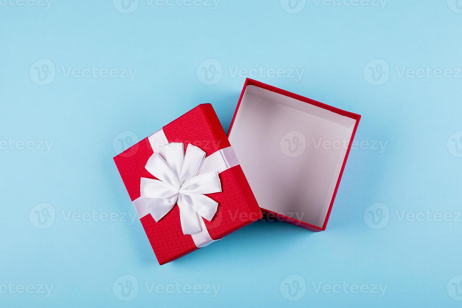 Open red gift box on background. Top view, flat lay, place for object. Mockup, holiday concept. photo