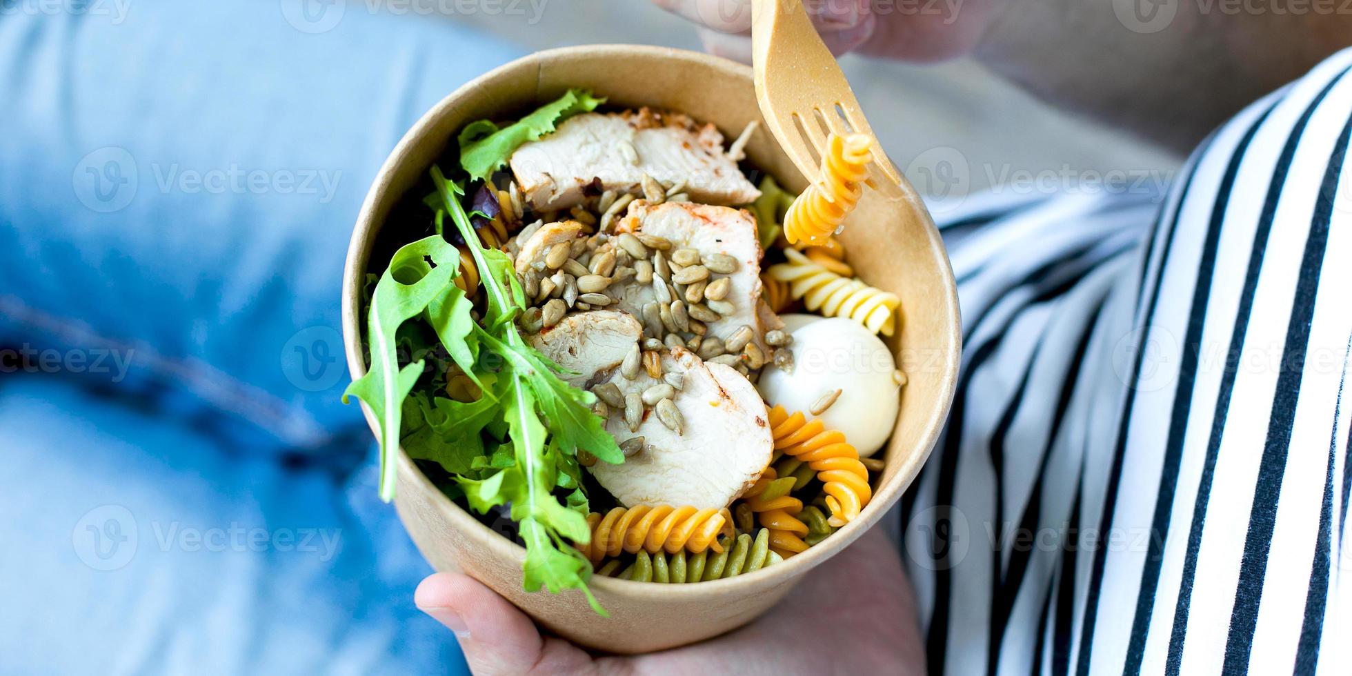 Eating healthy lunch bowl in man' s hands. Banner image for website photo