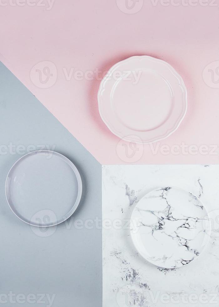 Gray, pink and marble plates on tricolor background. Beautiful light texture, abstract background photo