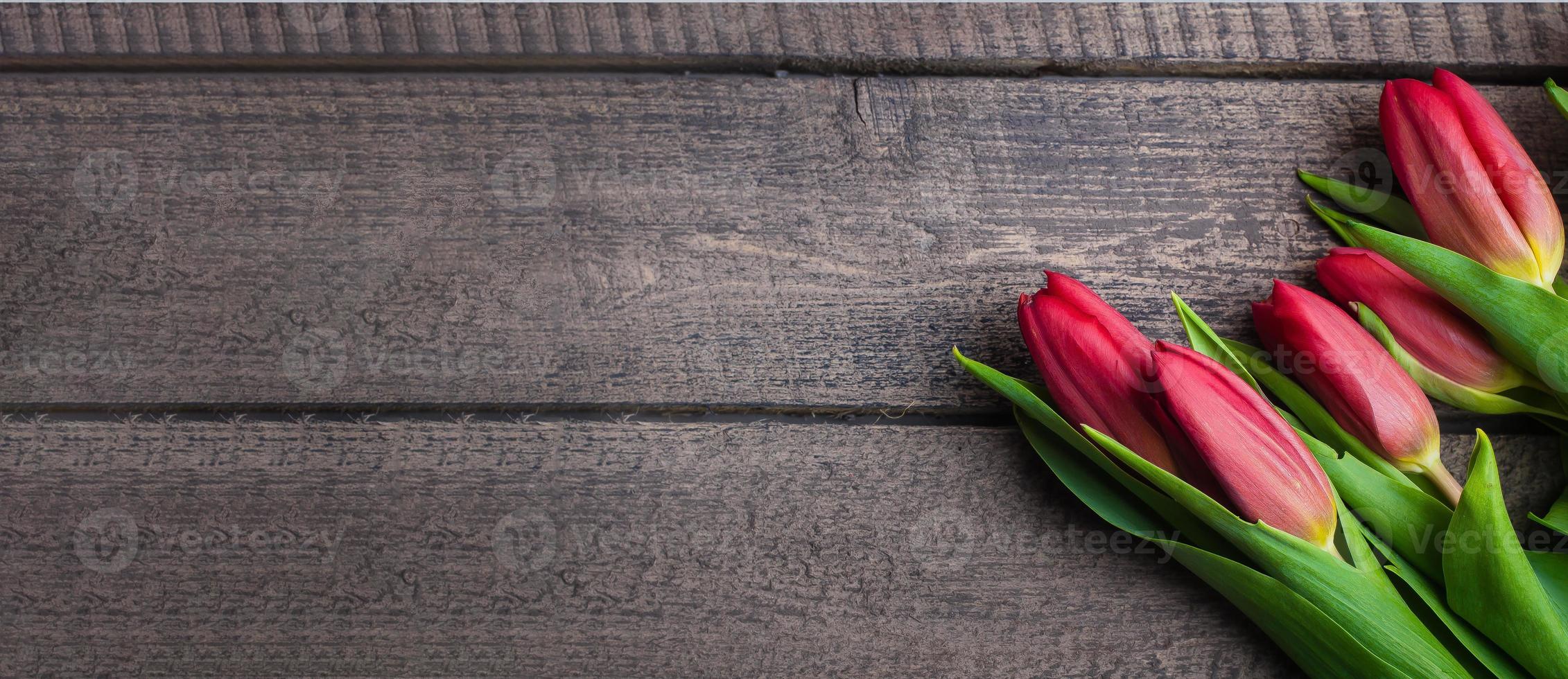 Spring tulips flowers on a old wooden background. Top view, copy space, place for text photo