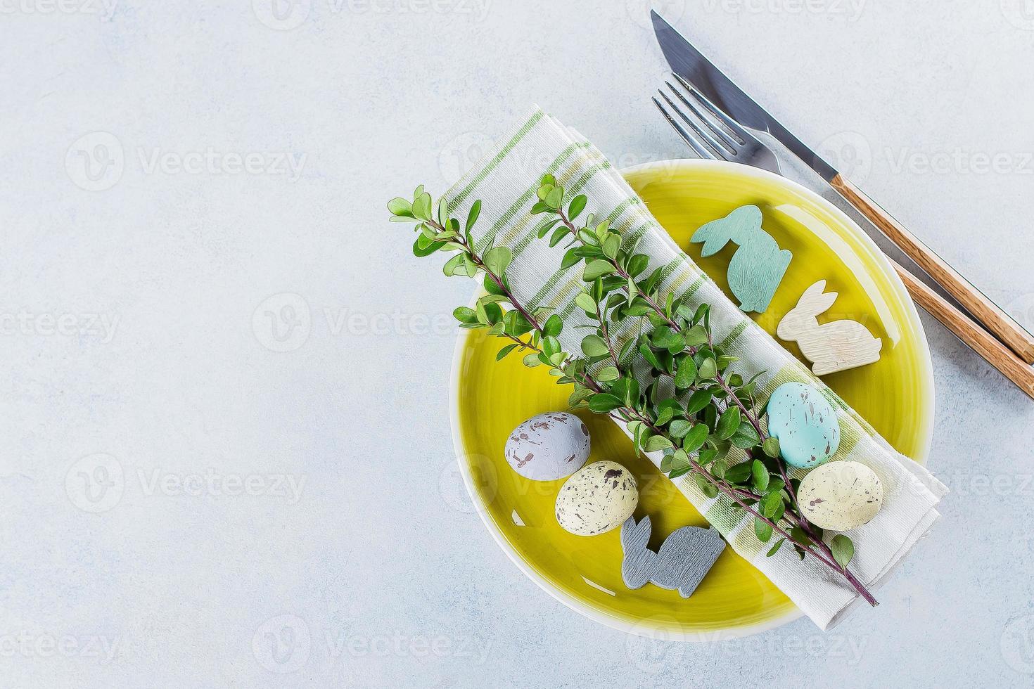 Festive table setting for holiday Easter dinner on light concrete table. Spring Holiday Card Concept photo