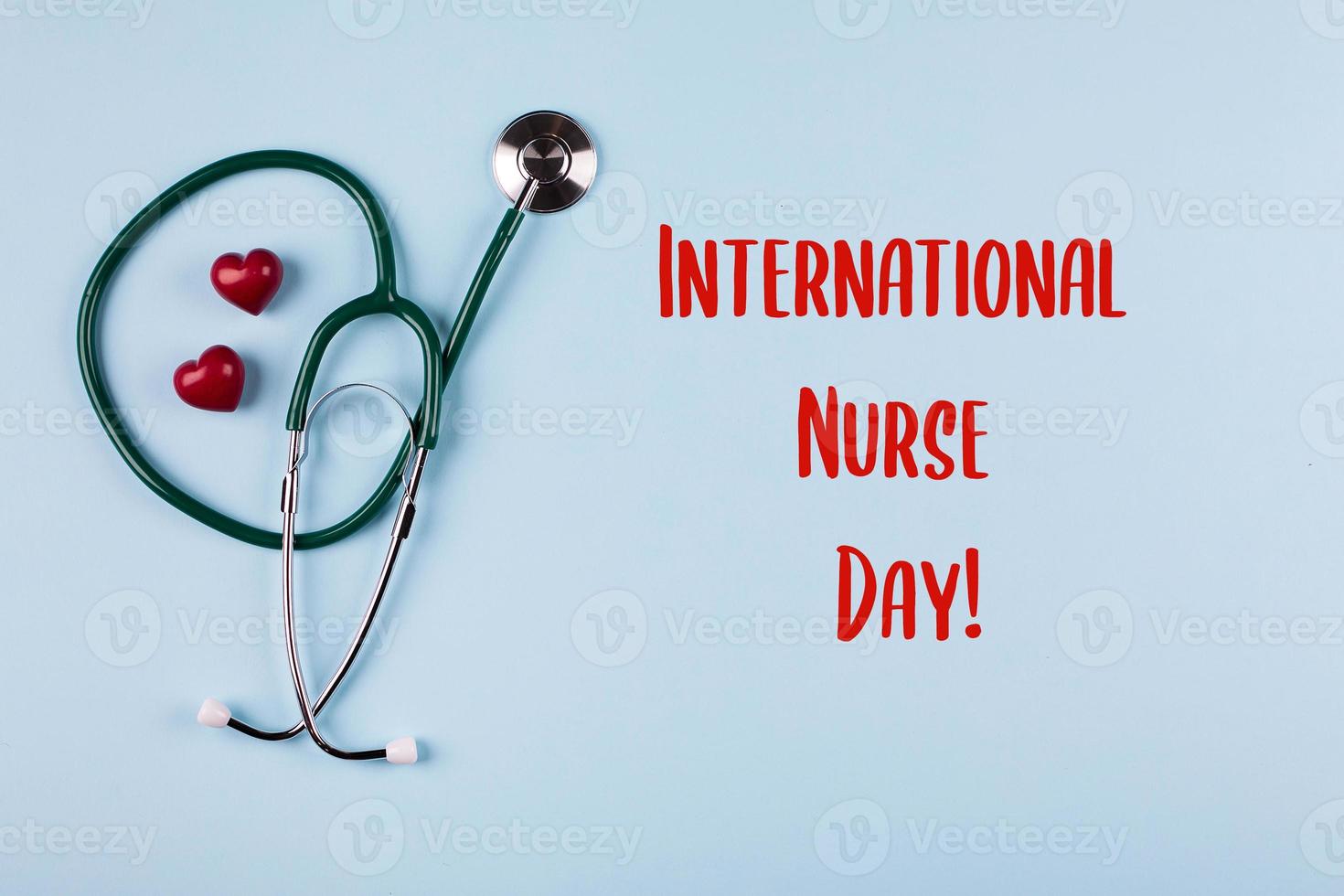 International Nurse Day Holiday Background. Medical stethoscope, two red hearts and wooden letters photo