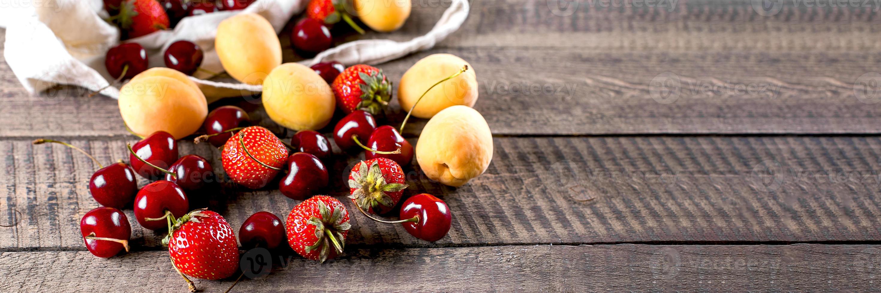 Reusable bag with apricot, strawberry and cherry. Zero waste concept. Banner image for website photo