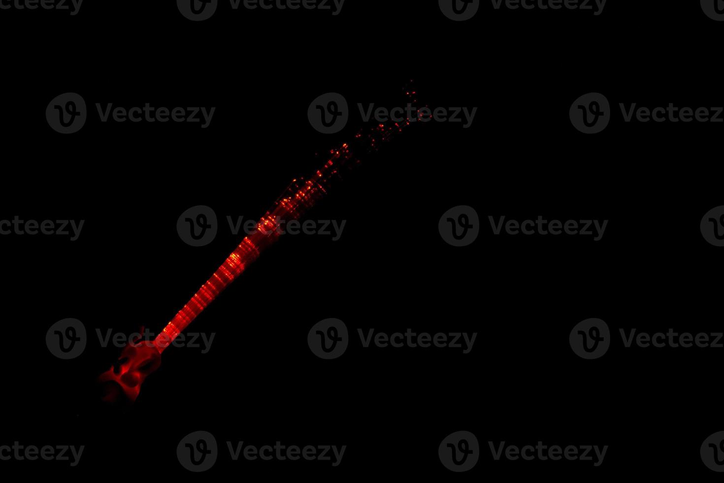 Illuminated fiber optics glowing on the black background photo