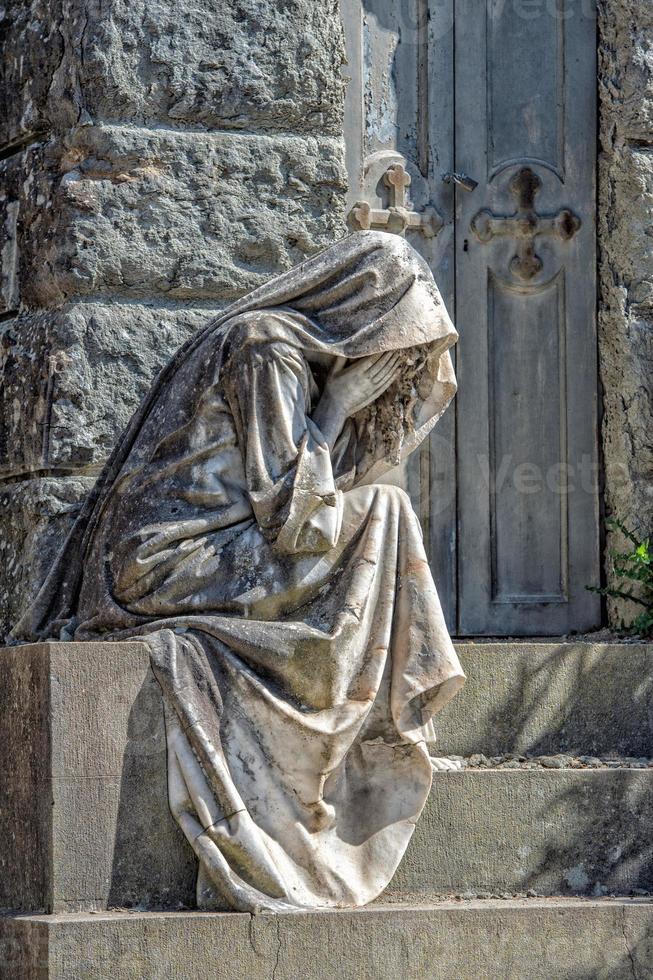 Widow marble statue outside a tomb photo