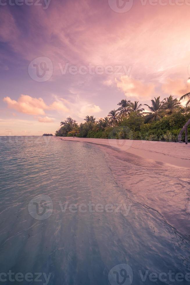 Tranquil vertical beach landscape. Sunset sea beautiful palm tree. Wonderful beach scenery. Tranquil and inspirational tropical nature view. Luxury beach resort sunset sky, calmness and inspire tropic photo