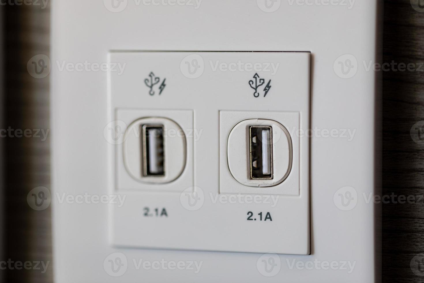 USB slot is attached to the wall for charging. USB socket port with USB signage icon on wooden wall background, Prepared to use. photo