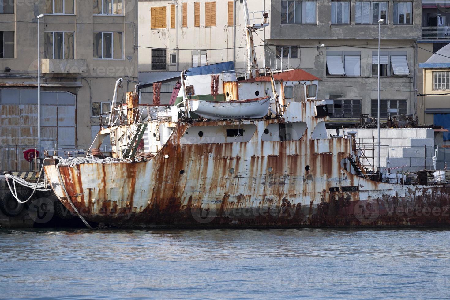 old rusted ship in harbor photo