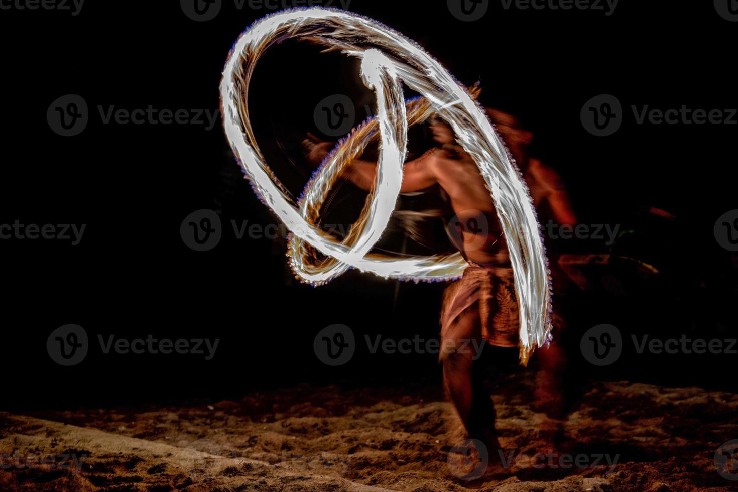 Fire dance Cook Islands polynesian dancer with pole of flames photo