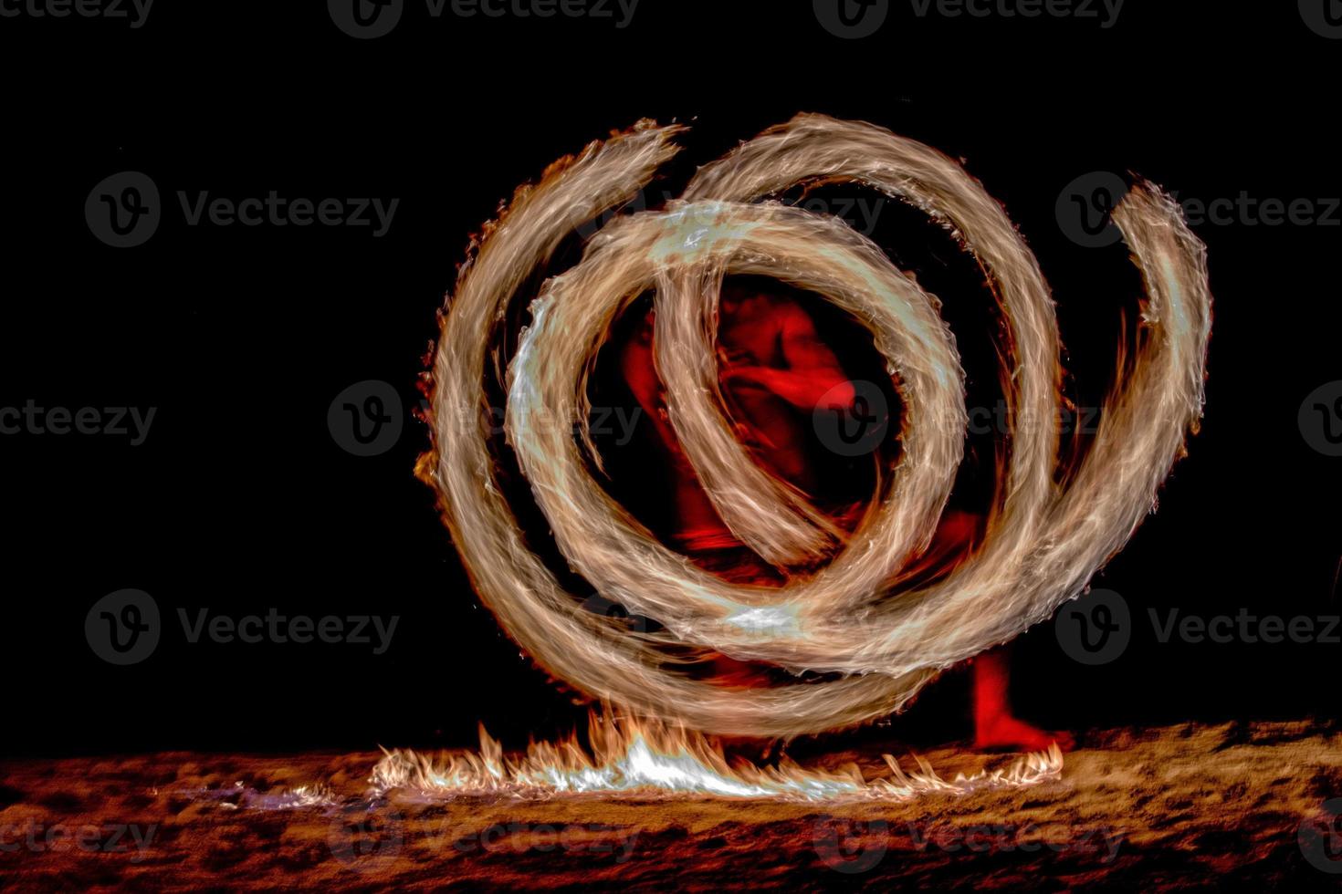 Fire dance Cook Islands polynesian dancer with pole of flames photo