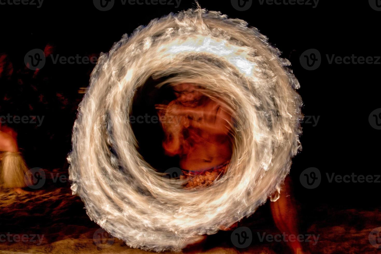 Fire dance Cook Islands polynesian dancer with pole of flames photo