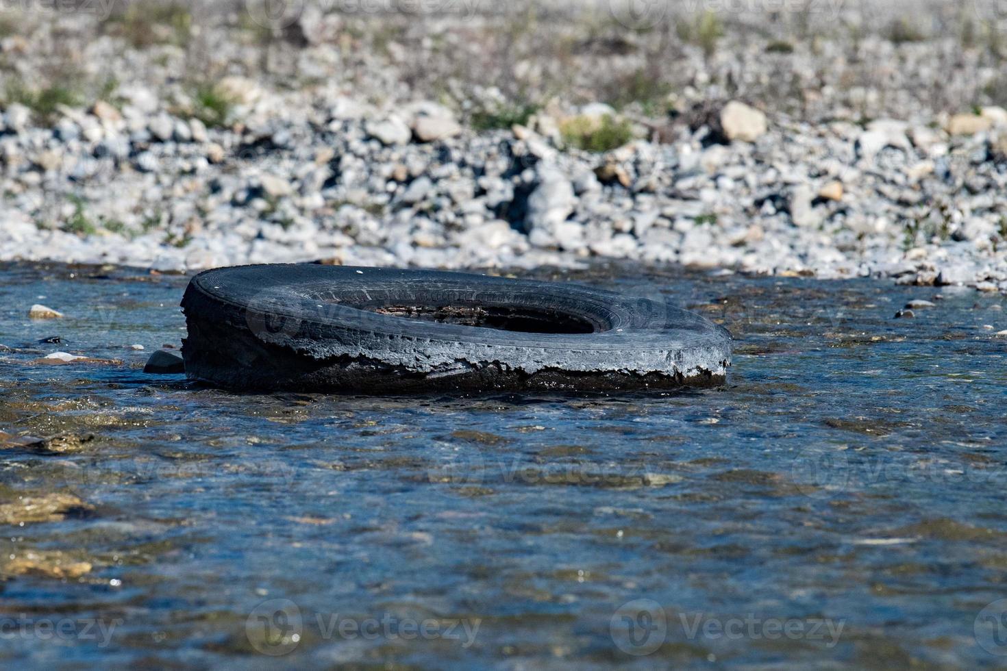 abandoned tire in a river photo
