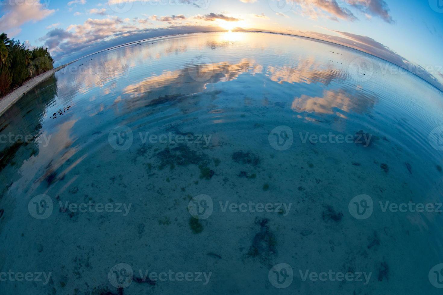 Sunset on polynesian white sand beach photo