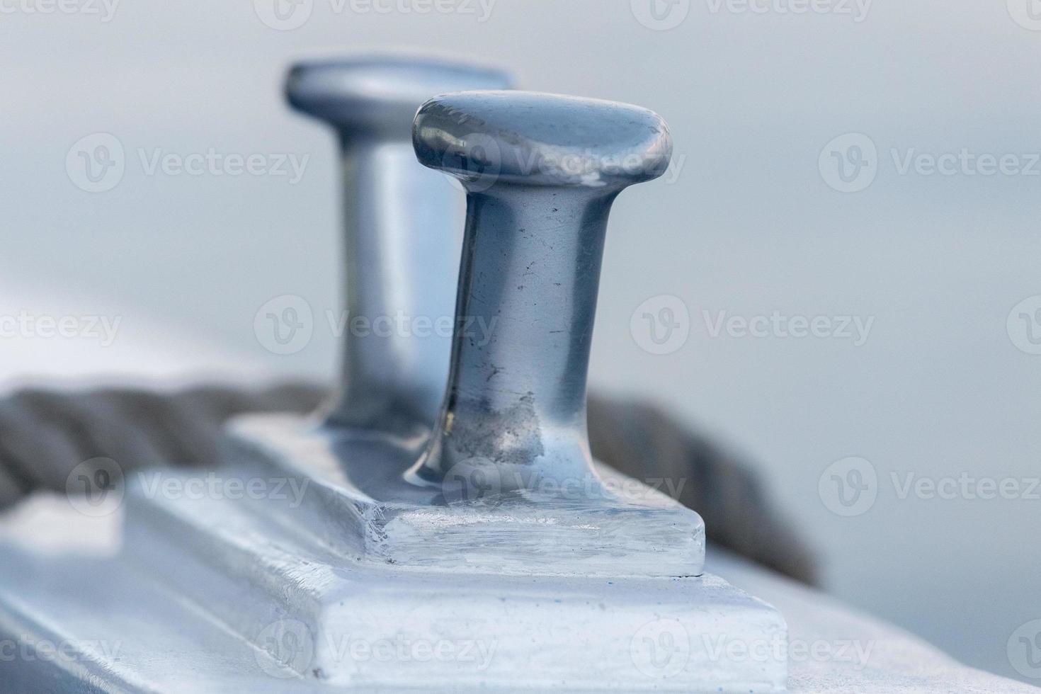boat bollard detail on blue water background photo