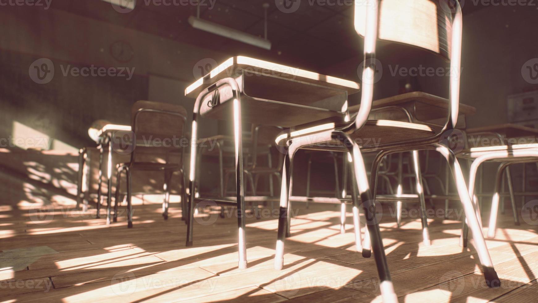 View to classroom with tables and small blackboard and grungy walls photo