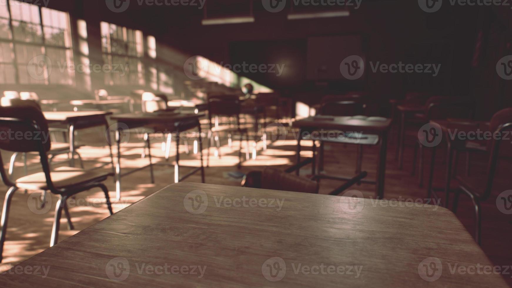View to classroom with tables and small blackboard and grungy walls photo