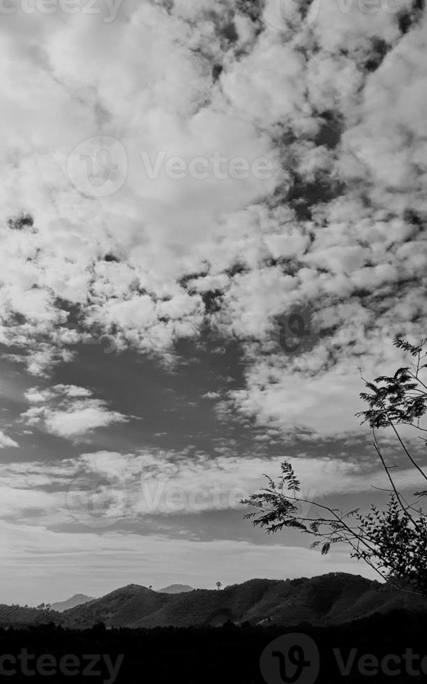 black-white picture vertically, dark sky white cloud above top view high mountain, landscape background around countryside. Thailland photo