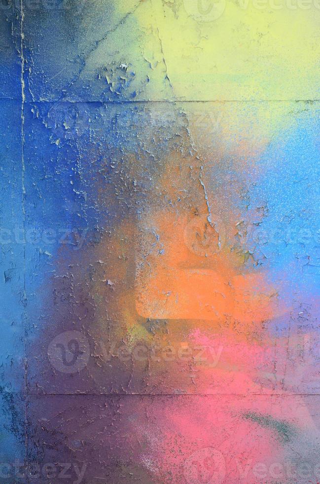 A large fragment of the graffiti pattern applied to the wall with aerosol paint. The gradient between several colors is carried out by spraying the paint. Abstract background image photo