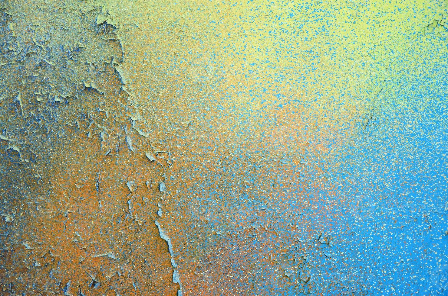 A large fragment of the graffiti pattern applied to the wall with aerosol paint. The gradient between several colors is carried out by spraying the paint. Abstract background image photo