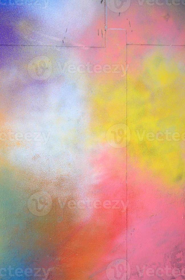 A large fragment of the graffiti pattern applied to the wall with aerosol paint. The gradient between several colors is carried out by spraying the paint. Abstract background image photo