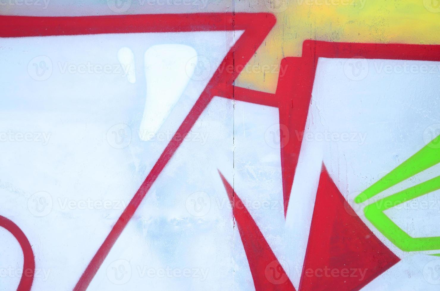 Close-up fragment of a graffiti drawing applied to the wall by aerosol paint. Background image of a modern composition of lines and colored areas. Street art concept photo
