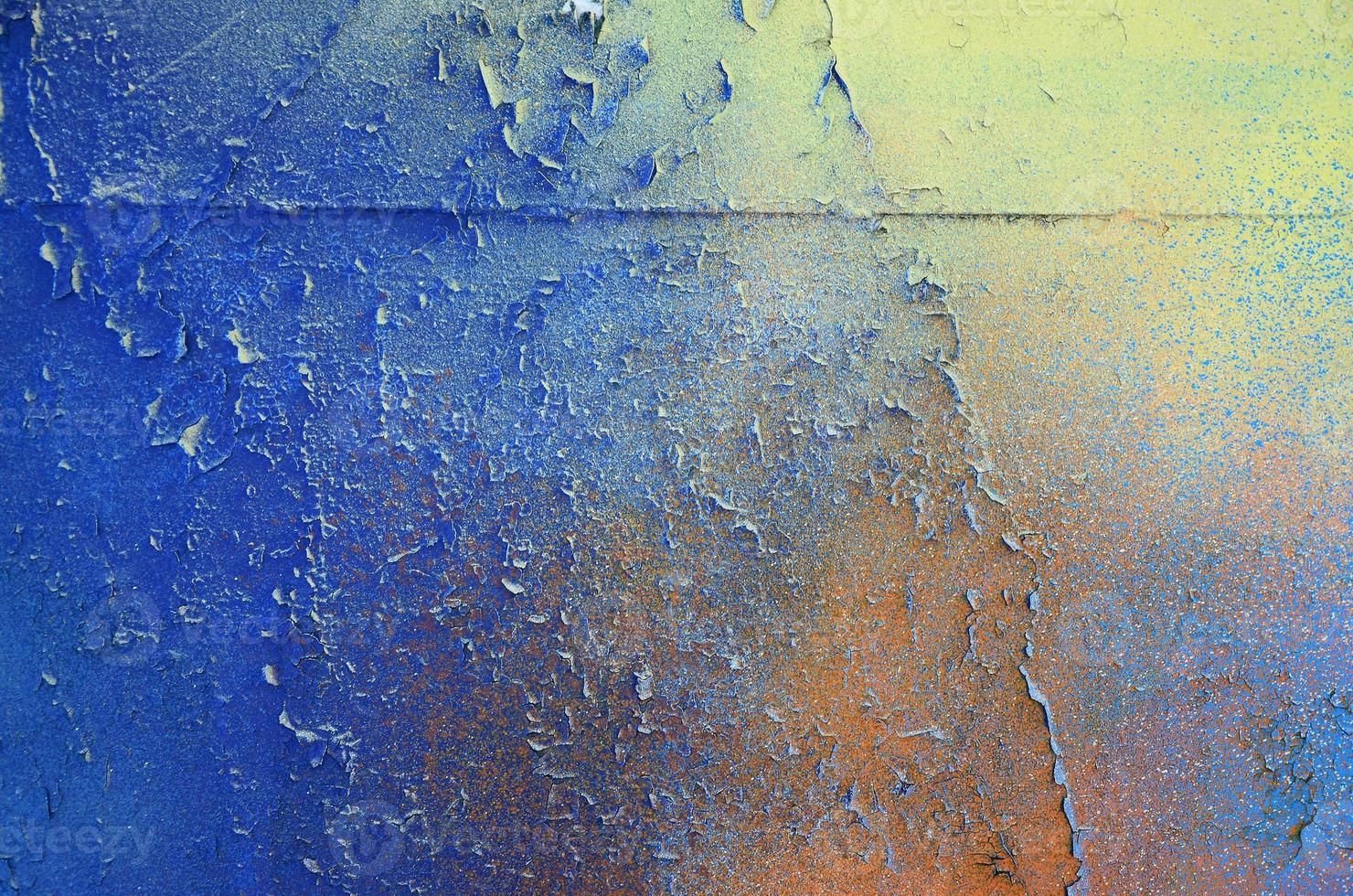 A large fragment of the graffiti pattern applied to the wall with aerosol paint. The gradient between several colors is carried out by spraying the paint. Abstract background image photo