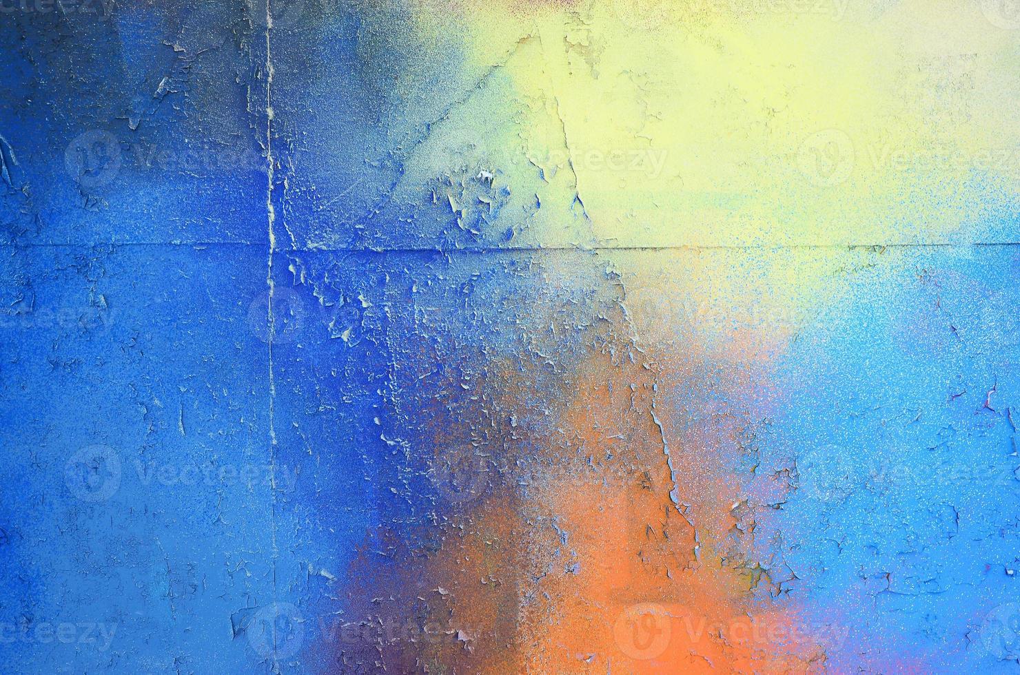 A large fragment of the graffiti pattern applied to the wall with aerosol paint. The gradient between several colors is carried out by spraying the paint. Abstract background image photo