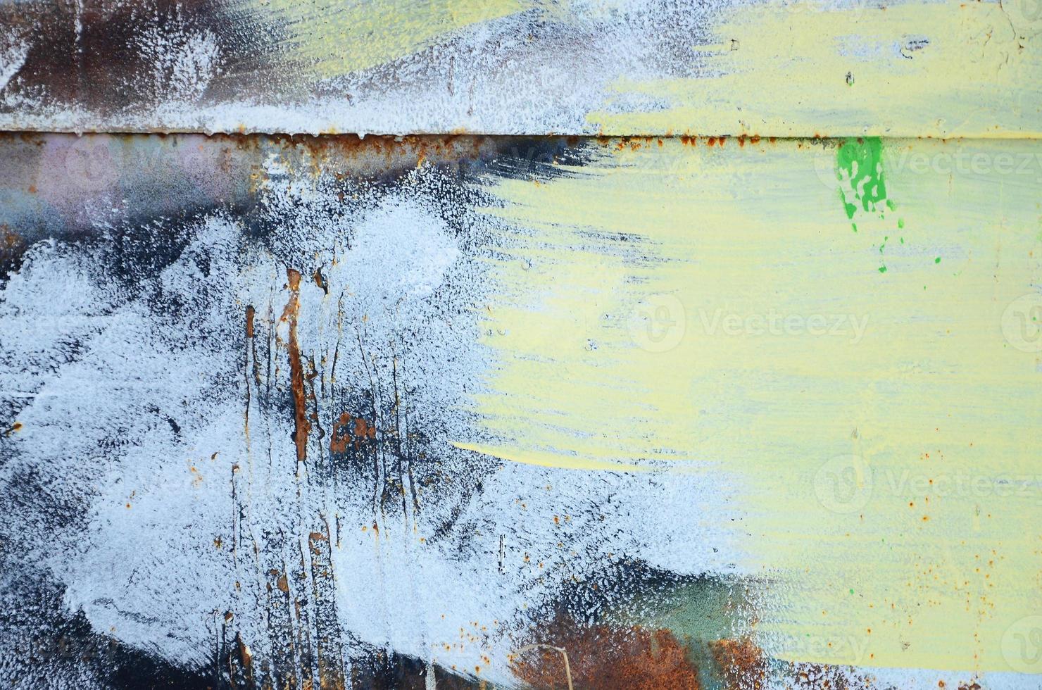 A large fragment of the graffiti pattern applied to the wall with aerosol paint. The gradient between several colors is carried out by spraying the paint. Abstract background image photo