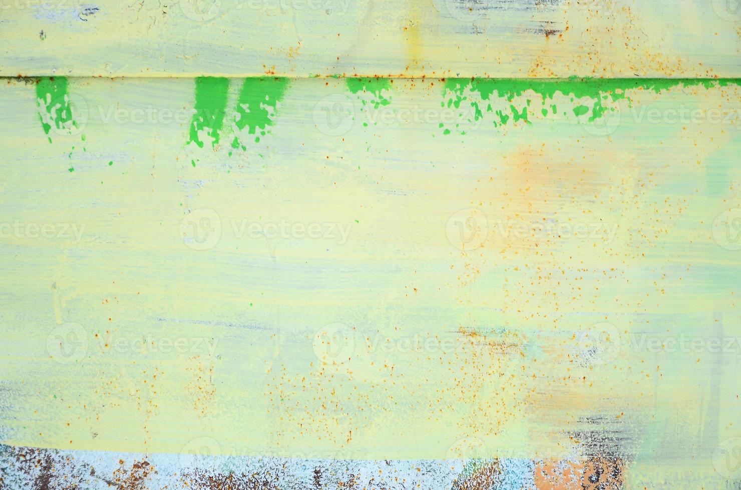 A large fragment of the graffiti pattern applied to the wall with aerosol paint. The gradient between several colors is carried out by spraying the paint. Abstract background image photo