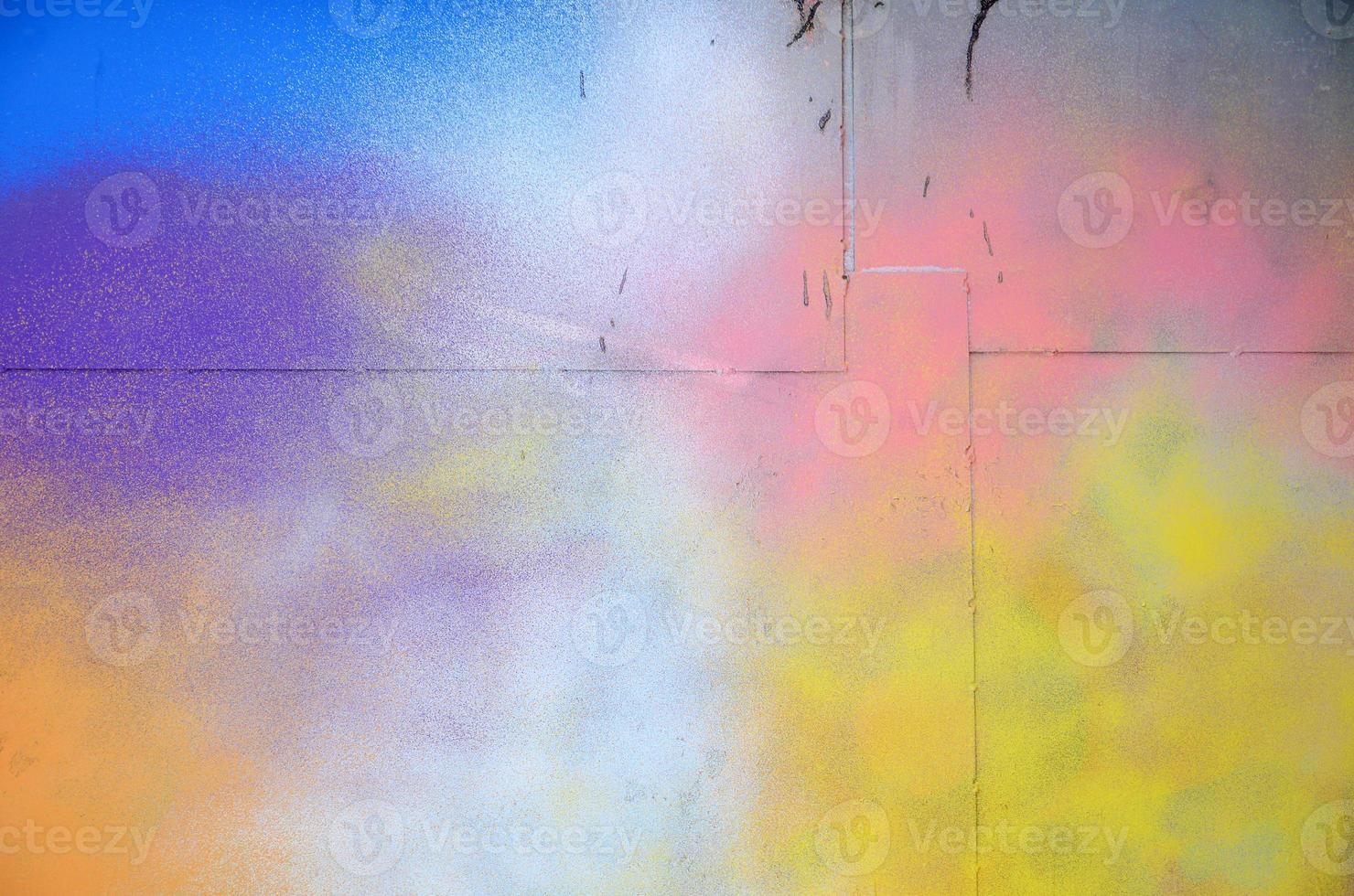 A large fragment of the graffiti pattern applied to the wall with aerosol paint. The gradient between several colors is carried out by spraying the paint. Abstract background image photo