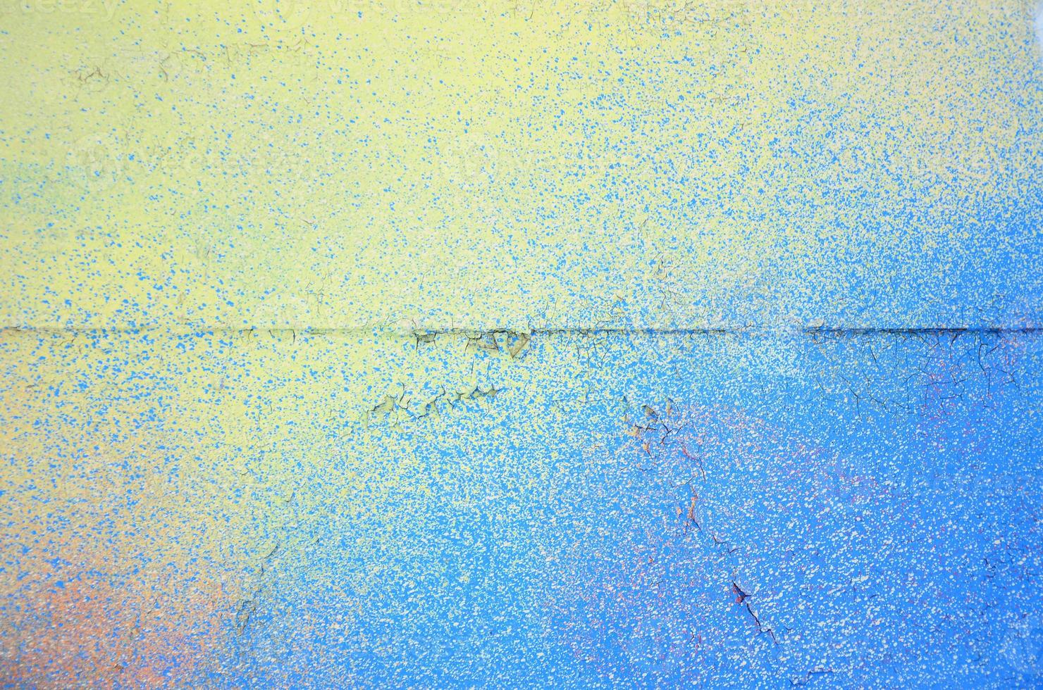A large fragment of the graffiti pattern applied to the wall with aerosol paint. The gradient between several colors is carried out by spraying the paint. Abstract background image photo