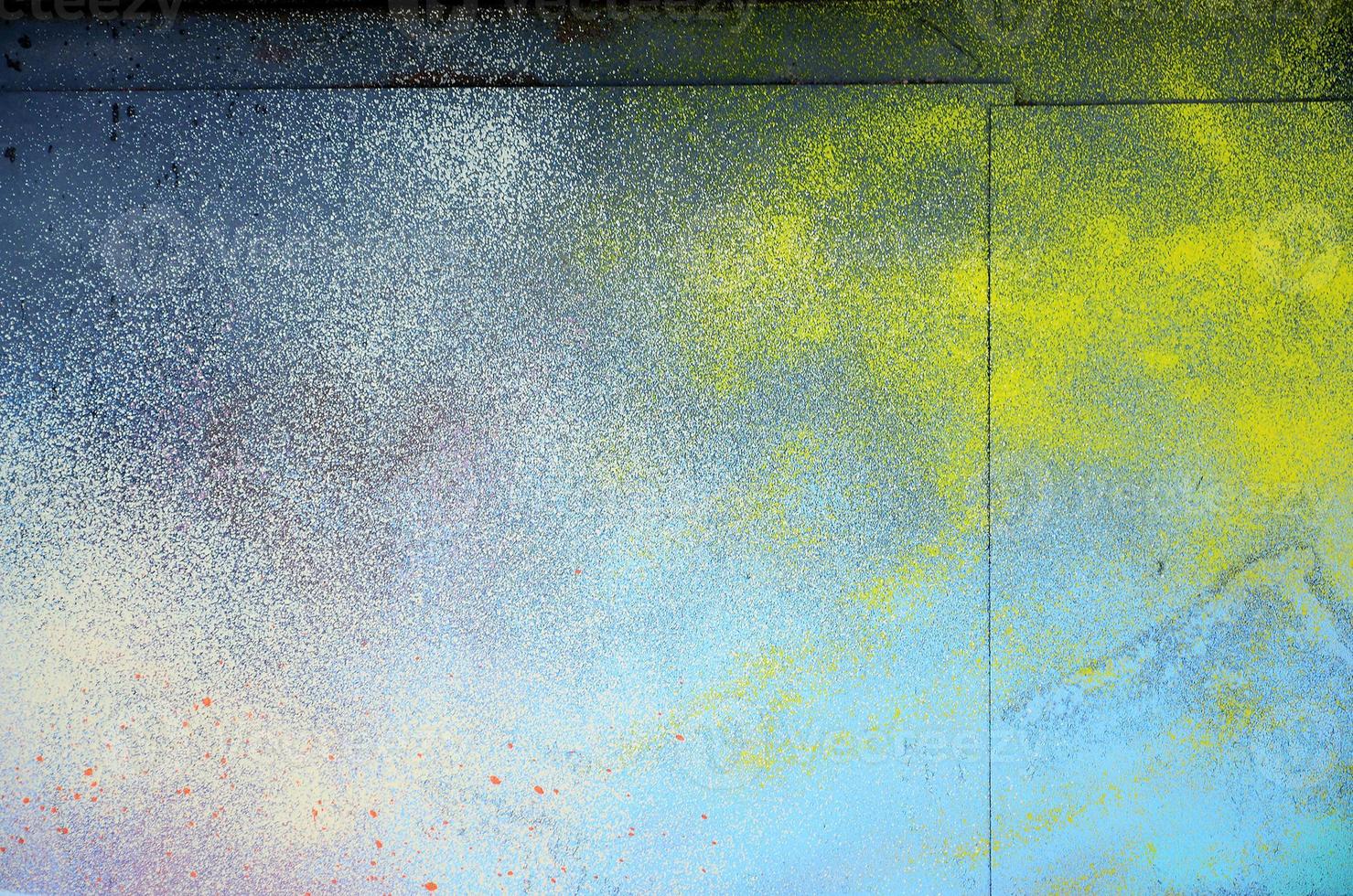 A large fragment of the graffiti pattern applied to the wall with aerosol paint. The gradient between several colors is carried out by spraying the paint. Abstract background image photo