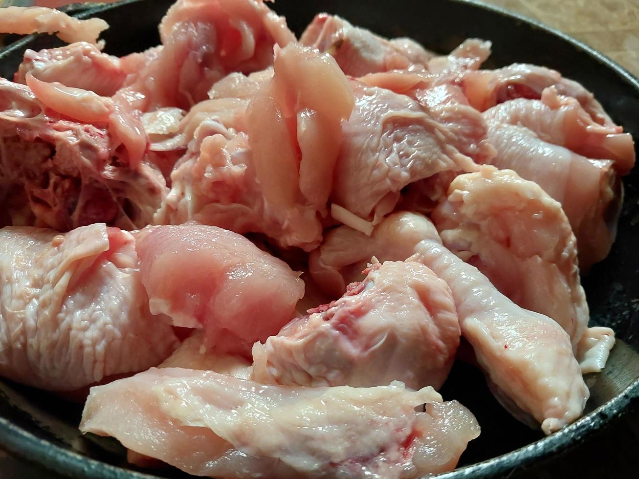 Cooking chopped chicken with an ax in a pan photo