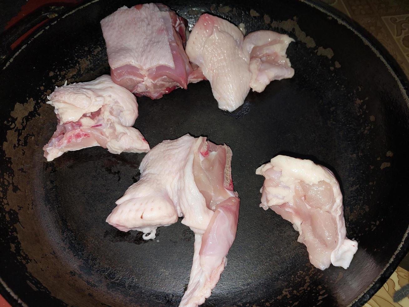 Cooking chopped chicken with an ax in a pan photo
