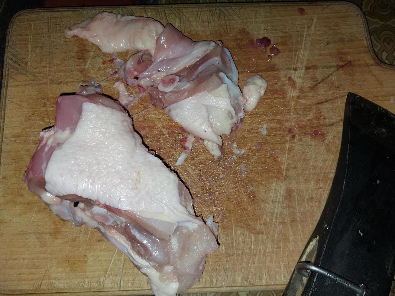 Cooking chopped chicken with an ax in a pan photo