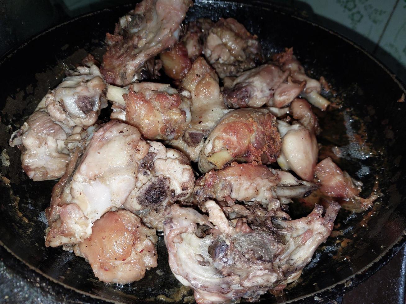 Cooking chopped chicken with an ax in a pan photo