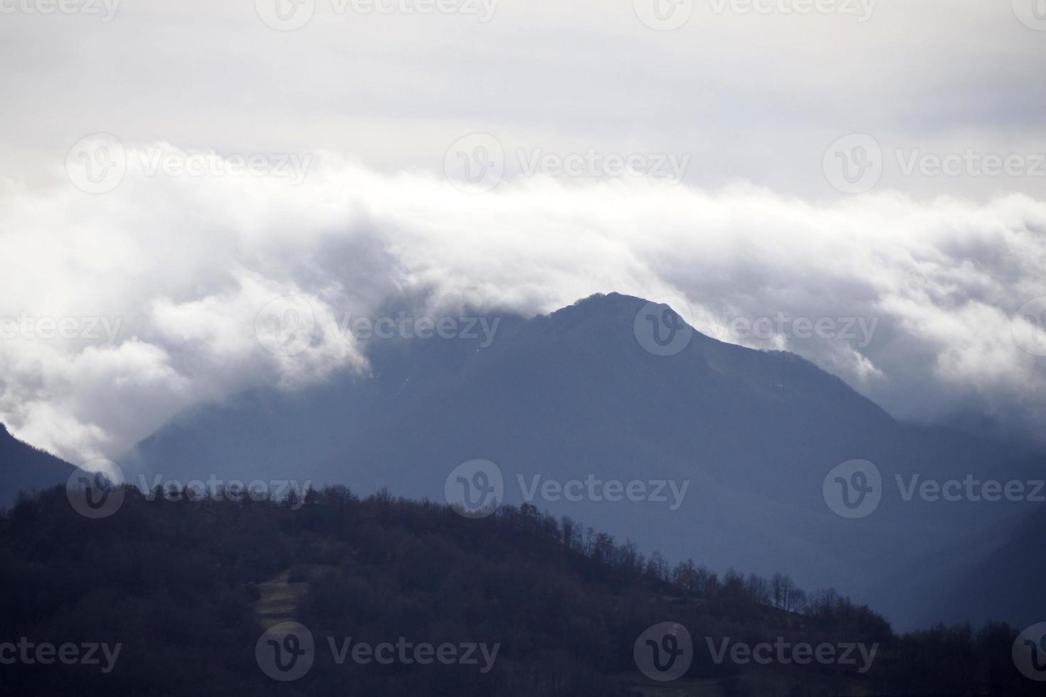 low clouds like fog in appennines valley around Bismantova stone a rock formation in the Tuscan-Emilian Apennines photo