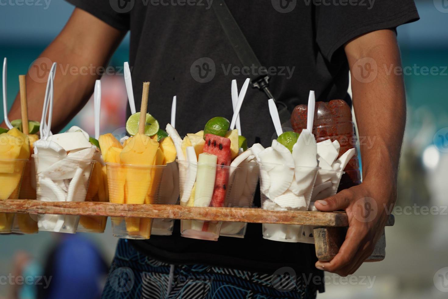 fruit for sale salesman on mexican sandy beach photo