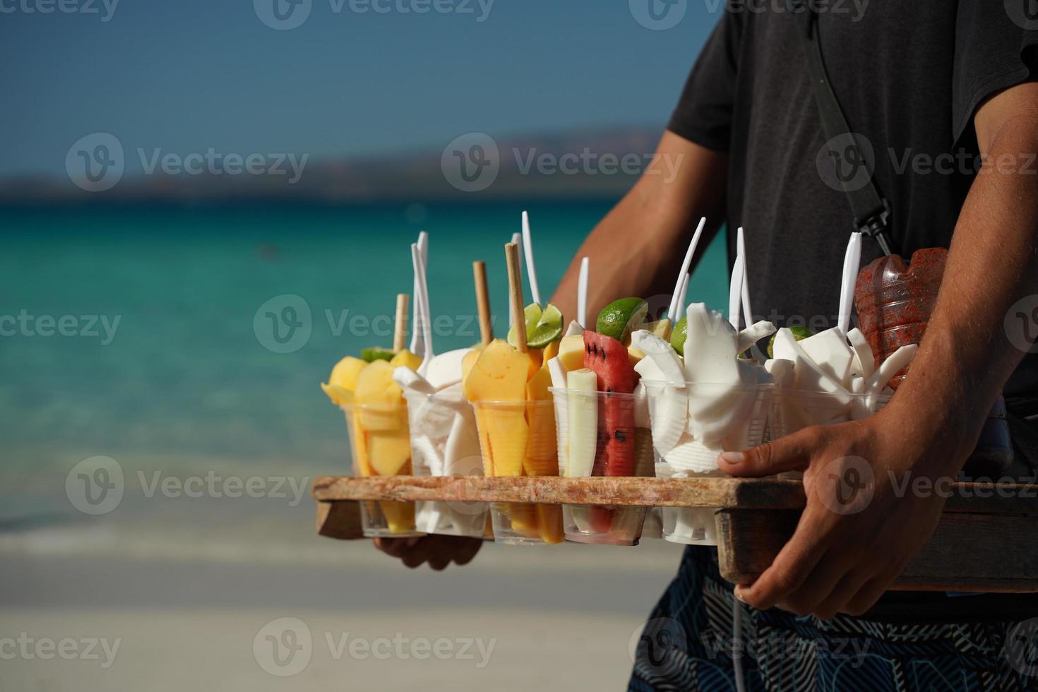 fruit for sale salesman on mexican sandy beach photo