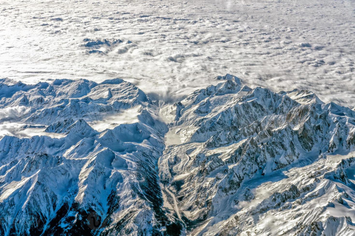 Alps mountains aerial view from airplane snow and avalanches photo