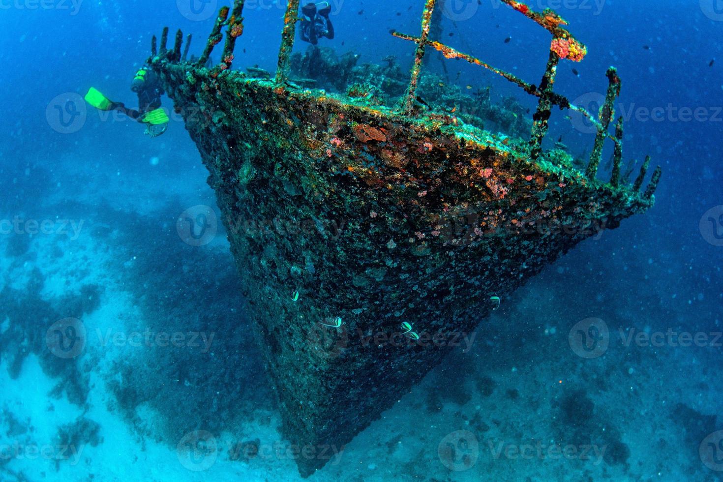 scuba diver diving Ship Wreck in maldives indian ocean photo