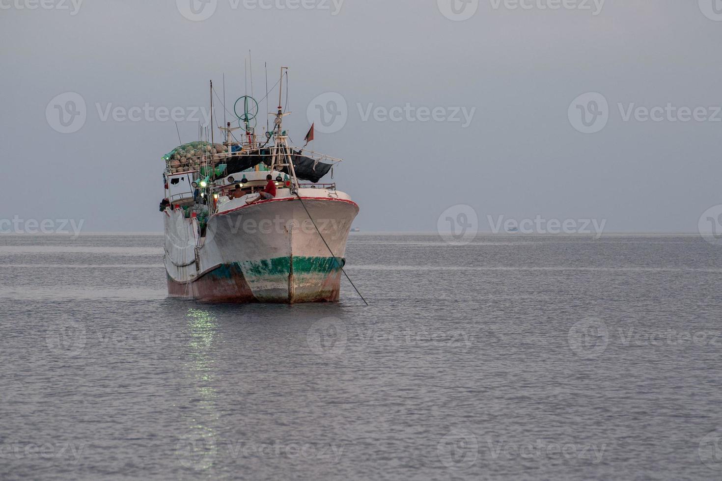 maldivian fishing boat in maldives at sunset photo