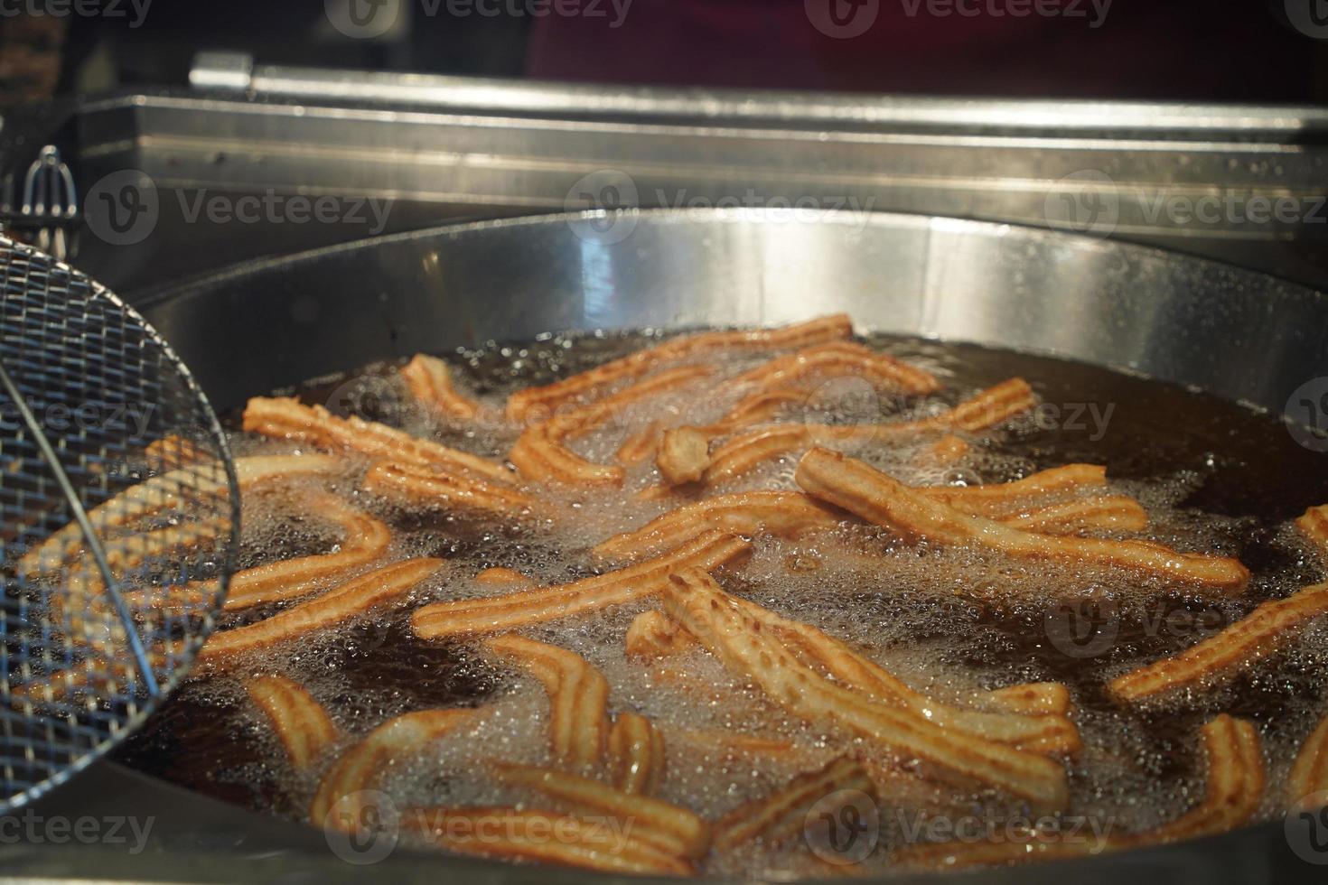 fried churros churro typical mexican sweet while frying photo