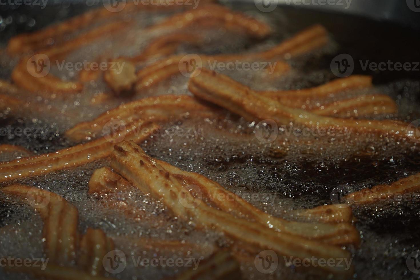 fried churros churro typical mexican sweet while frying photo