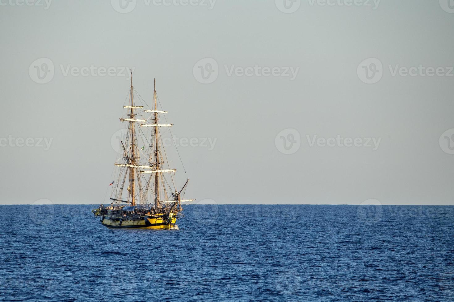Old vessel sail ship in open sea photo